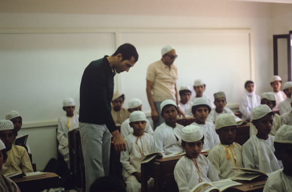 Egyptian teacher looking over the boys' school work