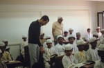 Egyptian teacher looking over the boys' school work