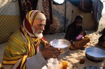 Harasiis elder drinking camel's milk