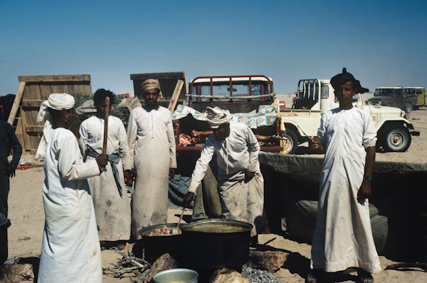 Men prepare wedding feast/camel's meat
