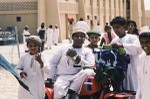 School boys with polio victim student on motorbike