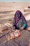 Woman weaving camel strap