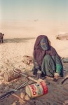 Woman weaving camel strap