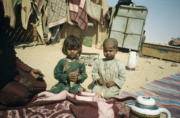 Young children eating bean snacks